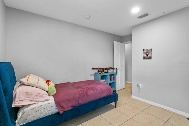 bedroom featuring tile patterned floors, visible vents, and baseboards