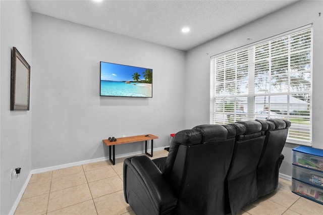 interior space with light tile patterned flooring, recessed lighting, baseboards, and a textured ceiling