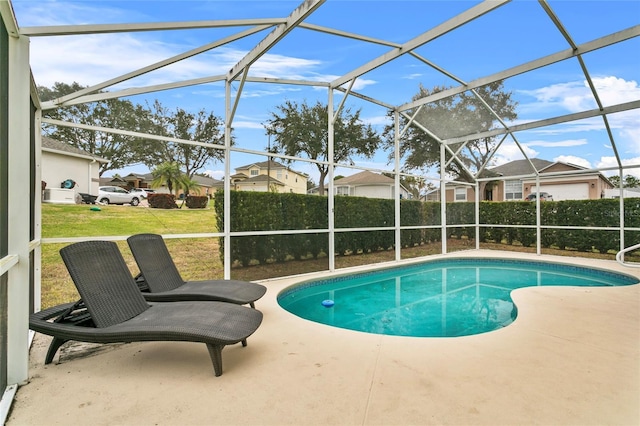 view of pool with a patio, a yard, a fenced in pool, and a lanai