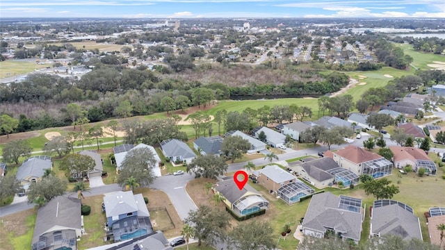 drone / aerial view with a residential view and golf course view