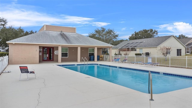 pool with a patio and fence