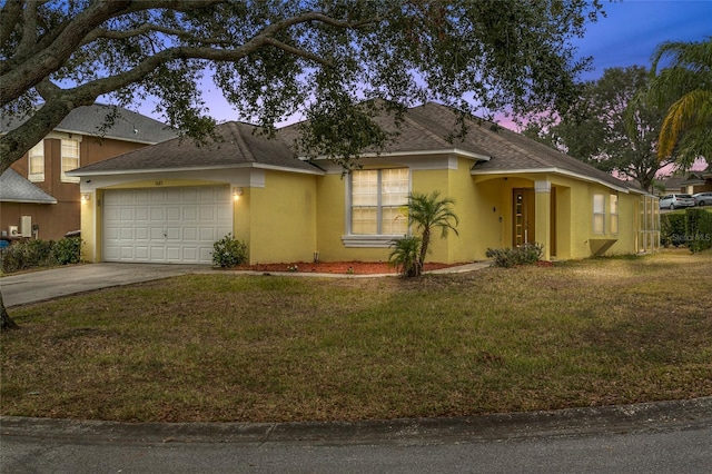 single story home with stucco siding, a lawn, concrete driveway, a shingled roof, and a garage