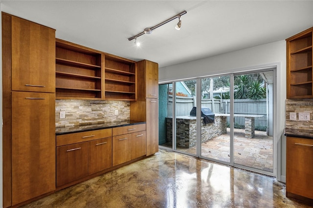 kitchen with tasteful backsplash and track lighting