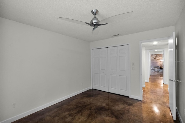 unfurnished bedroom with ceiling fan, a closet, and a textured ceiling