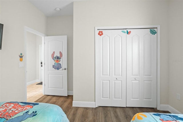 bedroom featuring wood-type flooring and a closet