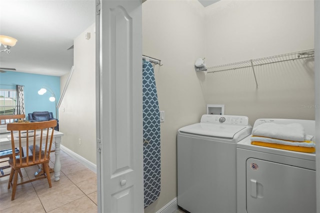 laundry room featuring washer and clothes dryer and light tile patterned floors