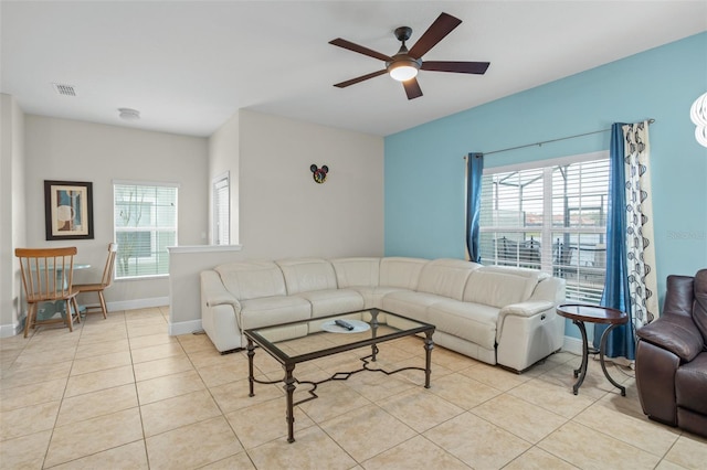 living room with ceiling fan and light tile patterned flooring