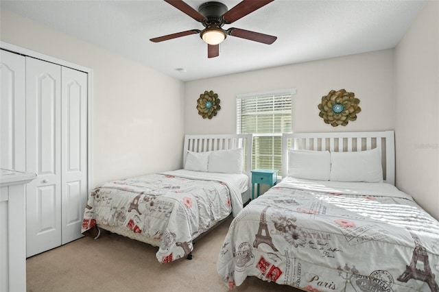 carpeted bedroom featuring a closet and ceiling fan