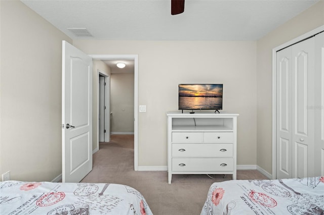 carpeted bedroom featuring ceiling fan and a closet