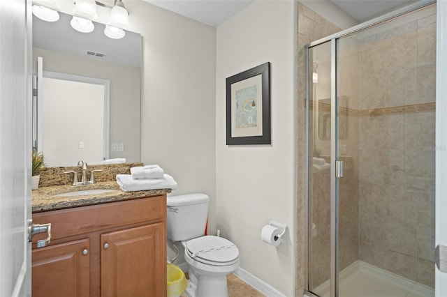 bathroom with vanity, an enclosed shower, and toilet