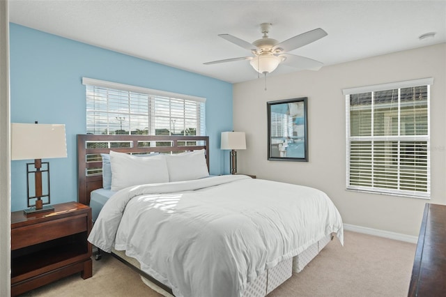 bedroom with ceiling fan and light carpet