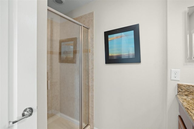 bathroom with vanity and an enclosed shower