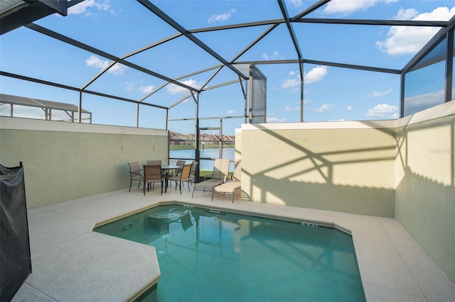 view of swimming pool featuring a patio, a water view, and a lanai