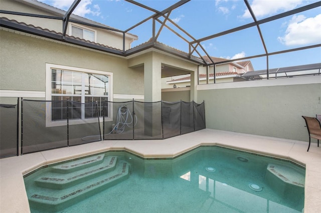 view of pool featuring glass enclosure