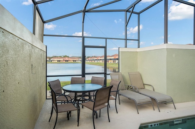 sunroom featuring a water view