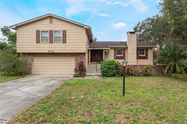 split level home featuring a front lawn and a garage