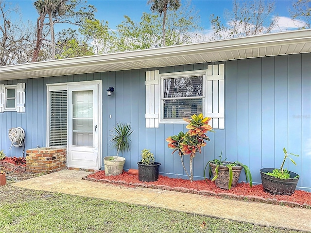 doorway to property with a lawn