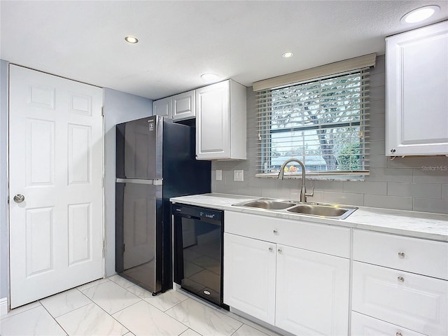 kitchen featuring sink, white cabinets, dishwasher, and stainless steel refrigerator