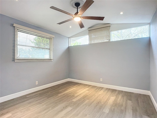 spare room with light hardwood / wood-style floors, ceiling fan, and vaulted ceiling