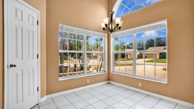 interior space with tile patterned floors and a chandelier