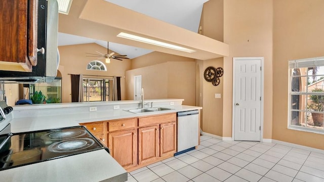 kitchen with ceiling fan, lofted ceiling, sink, light tile patterned flooring, and stainless steel appliances