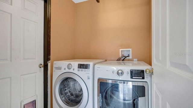 washroom with independent washer and dryer