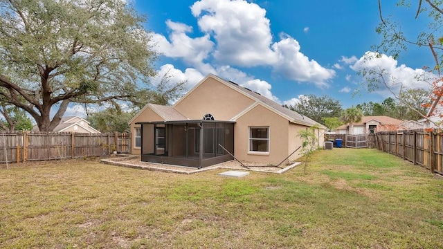 back of property featuring a yard and a sunroom