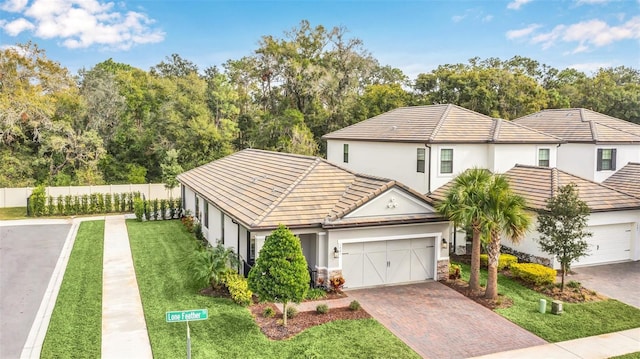 view of front of home with a garage and a front lawn