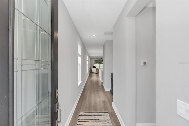 hall with hardwood / wood-style floors