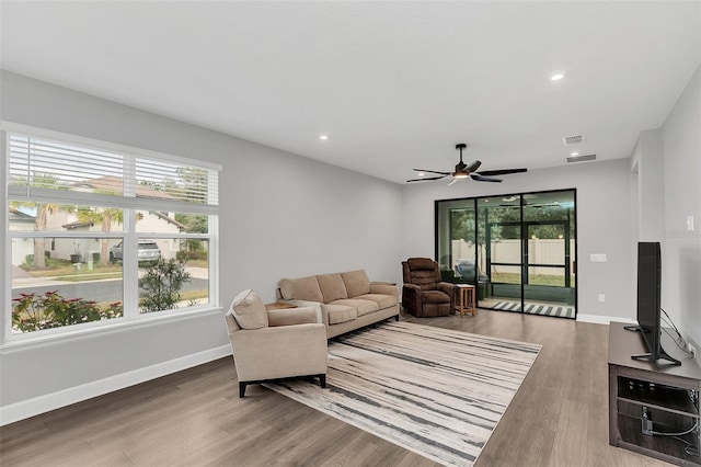 living room with hardwood / wood-style floors, a healthy amount of sunlight, and ceiling fan