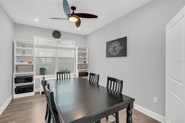 dining room with dark hardwood / wood-style floors and ceiling fan