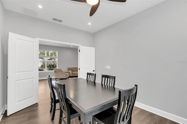 dining room featuring ceiling fan and dark wood-type flooring