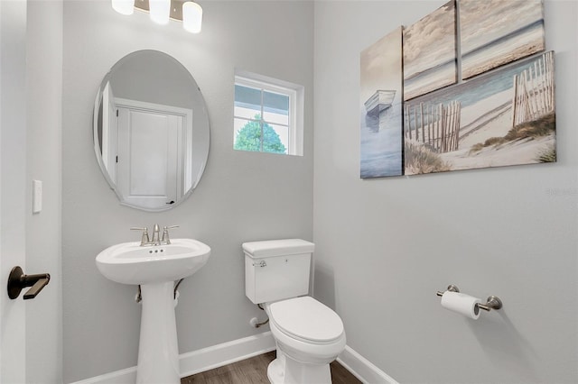 bathroom with toilet and hardwood / wood-style flooring