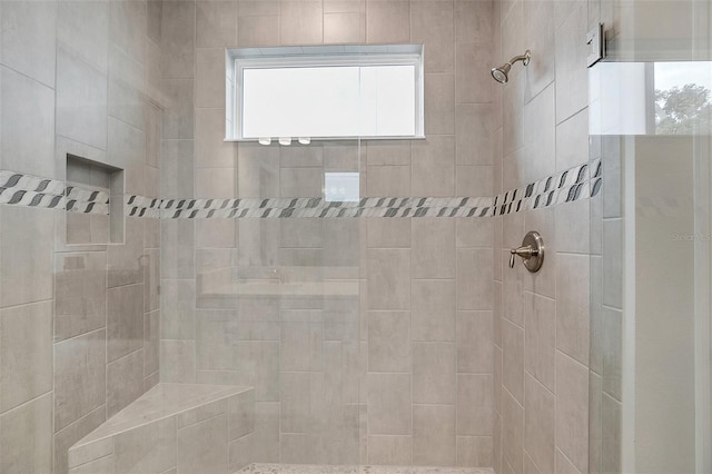 bathroom with a tile shower