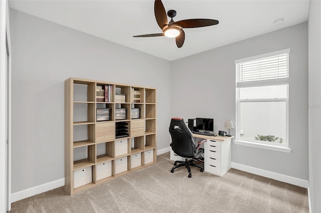 carpeted office space featuring ceiling fan