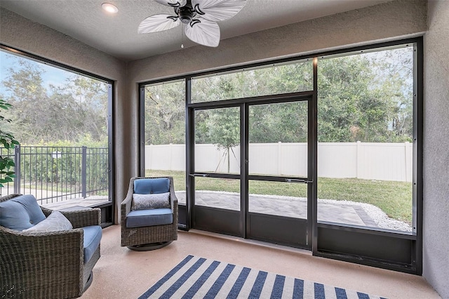 sunroom featuring ceiling fan