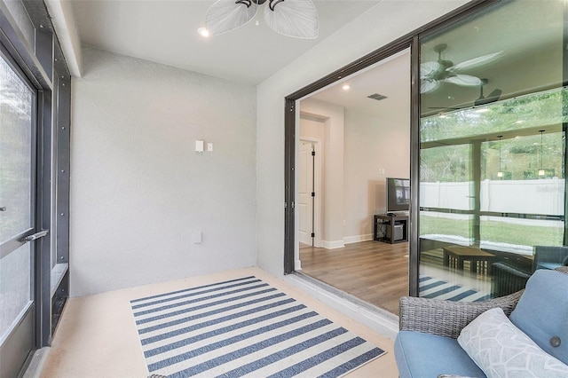 sunroom / solarium featuring ceiling fan and plenty of natural light