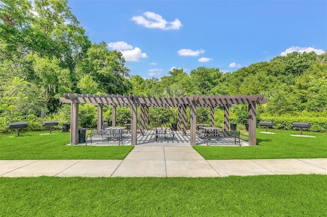 view of property's community featuring a patio area, a lawn, and a pergola