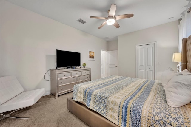 carpeted bedroom featuring a closet and ceiling fan