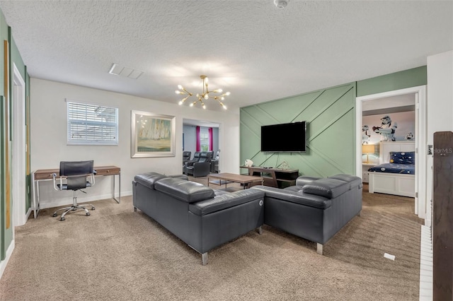 living room with a textured ceiling, an inviting chandelier, and carpet floors