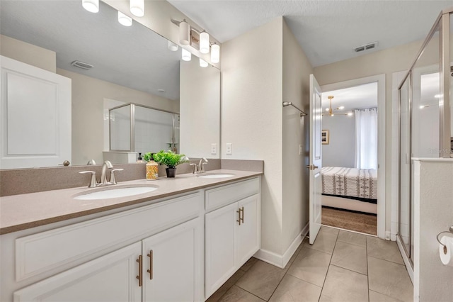 bathroom featuring walk in shower, tile patterned floors, and vanity