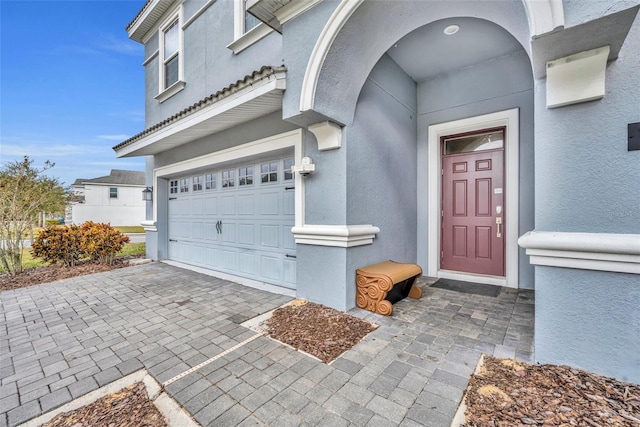 view of exterior entry with a garage