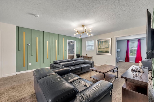 living room featuring an inviting chandelier, a textured ceiling, and carpet flooring