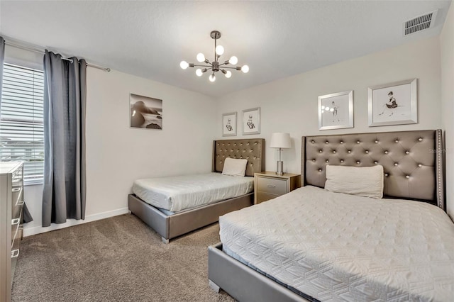 bedroom with a notable chandelier and carpet flooring