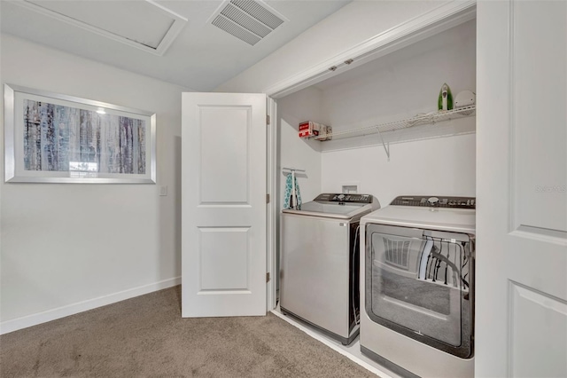 washroom with light colored carpet and washing machine and dryer