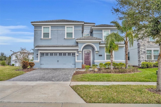 view of front of home with a front yard and a garage