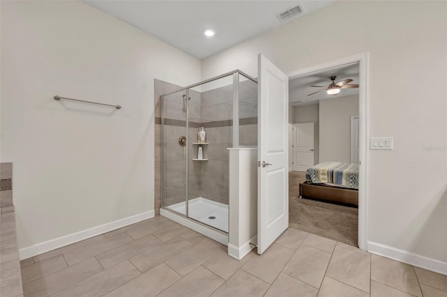 bathroom with tile patterned floors, a shower with shower door, and ceiling fan