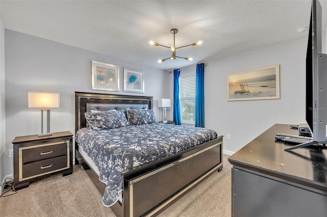 bedroom featuring a textured ceiling, light carpet, and a chandelier