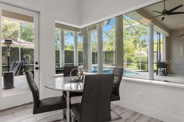 sunroom featuring ceiling fan and a wealth of natural light