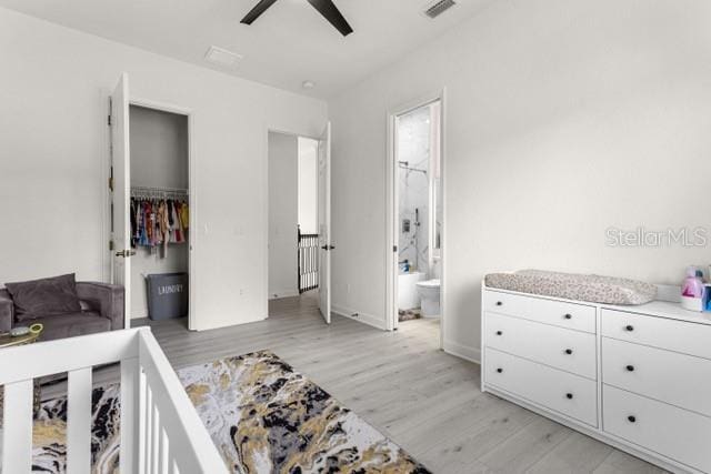 bedroom with ensuite bathroom, ceiling fan, and light hardwood / wood-style floors